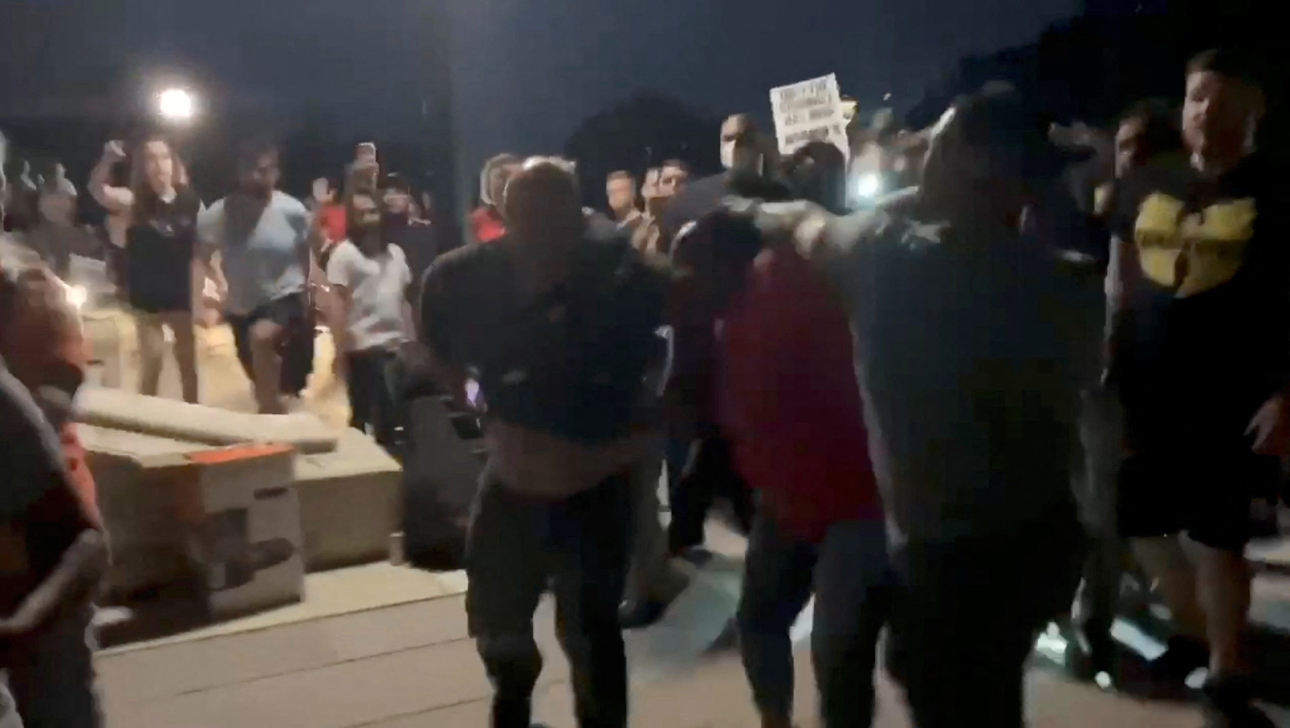 <p>State Senate Candidate Jennifer Rourke is punched by off-duty police officer and Republican rival for state Senate, Jeann Lugo at abortion rights rally in Rhode Island, U.S.  June 26, 2022</p>