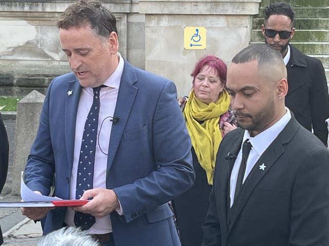 <p>Ben Mwangi (right) listens as Detective Superintendent Darren George of South Wales Police reads a statement after John Cole, Angharad Williamson and a 14-year-old boy were found guilty of murder (Rod Minchin/PA)</p>