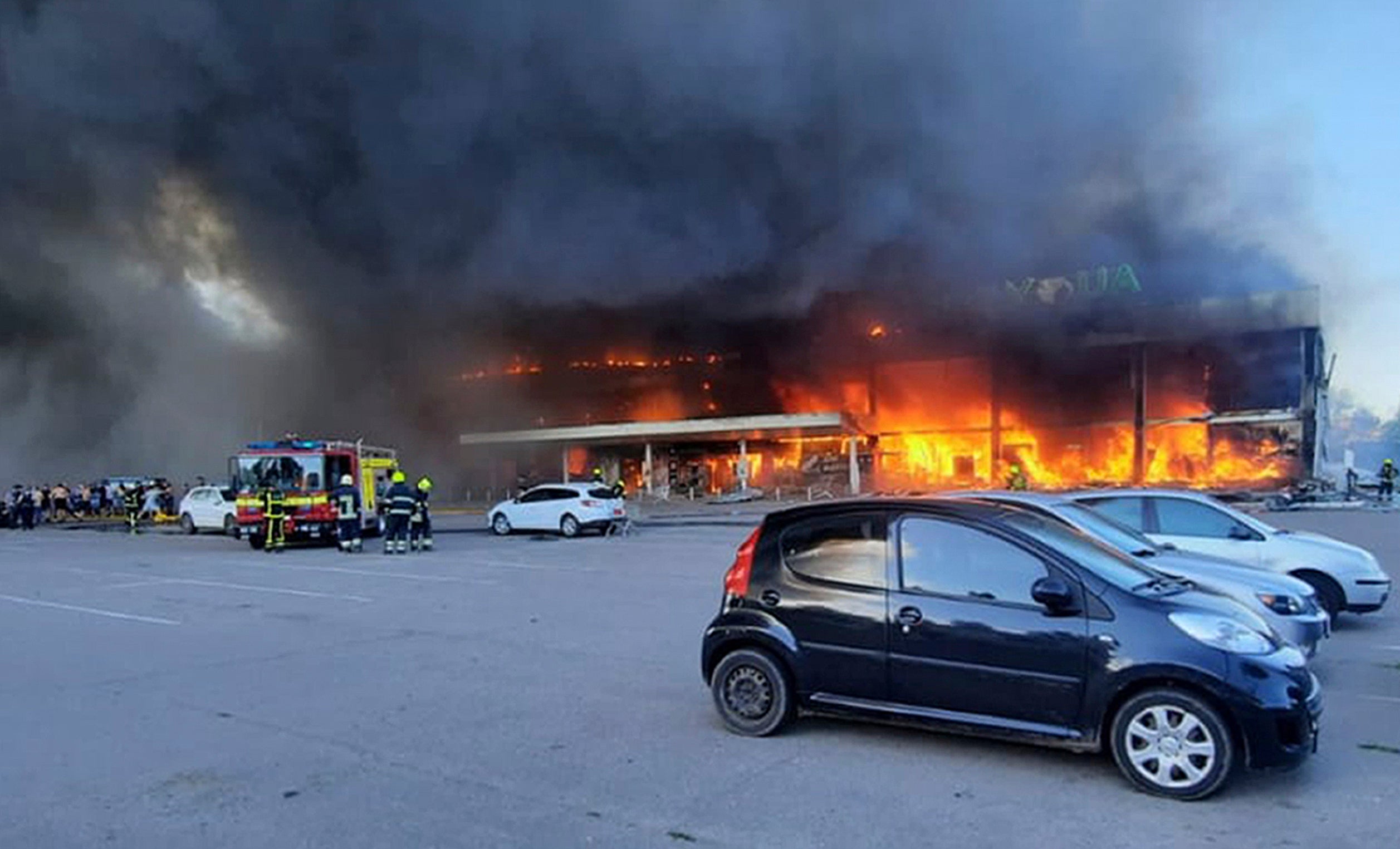 Firefighters at the shopping centre burned after a rocket attack in Kremenchuk (Ukrainian State Emergency Service/AP)