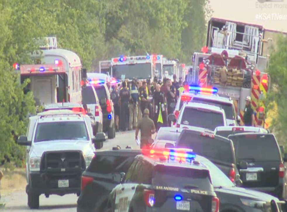 <p>First responders at the scene of an abandoned trailer where at least 40 migrants were reported to have been found dead </p>