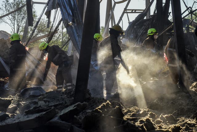 <p>Firefighters clean the rubble of the destroyed Amstor shopping mall in Kremenchuk</p>