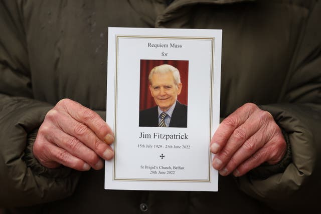 A mourner holds an order of service at the funeral of long-time owner of the Irish News newspaper, James Fitzpatrick (PA)