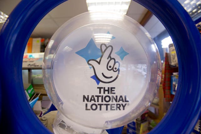 National Lottery operator Camelot has flagged signs that players had tightened their belts (PA)