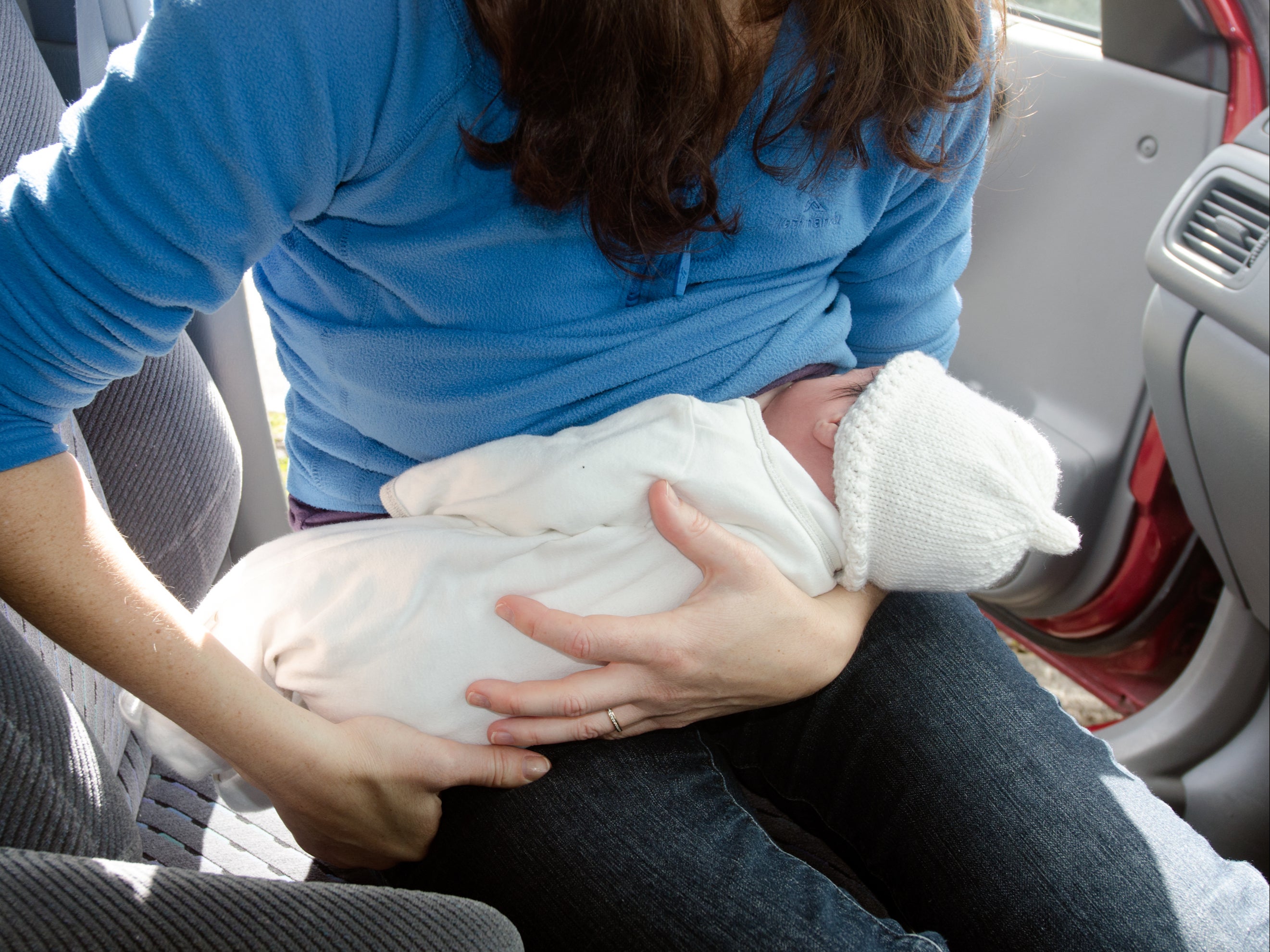 The woman was breastfeeding her baby in her car