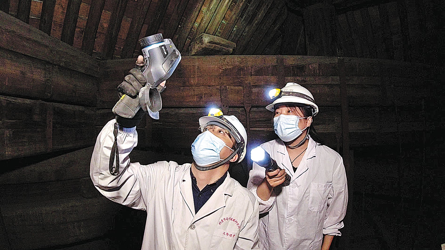 Zhang and a colleague conduct infrared thermography tests of an ancient building’s roof boarding