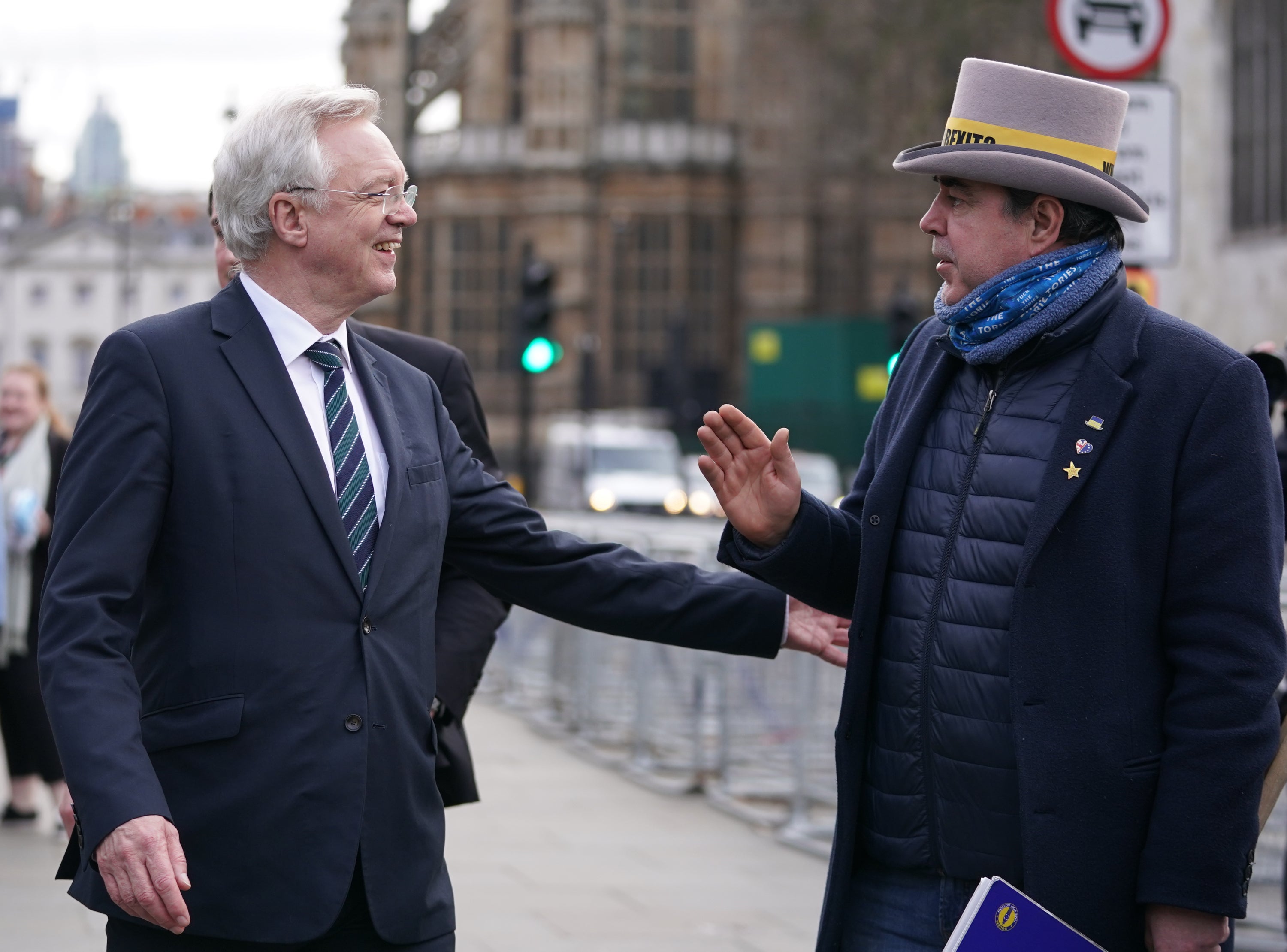 MP David Davis speaks to anti-Brexit protester Steve Bray (Kirsty O’Connor/PA)