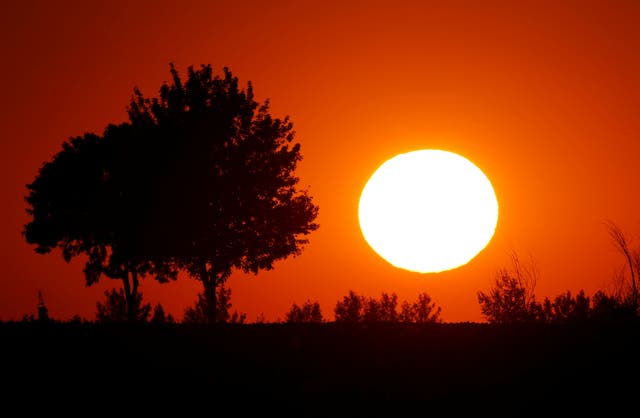 <p>The sun sets as a heatwave hits in Baralle, France, on 24 June 2020 </p>