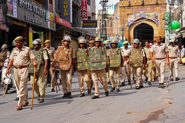 <p>Policemen carry out a flag march through a street in Ajmer city in Rajasthan on 29 June following the murder of a Hindu tailor allegedly by two Muslim men in Udaipur</p>