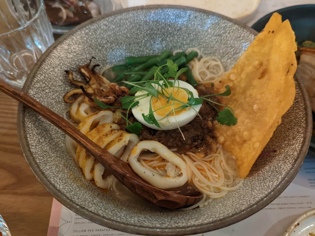 This unqiue dish mixes seafood, lemongrass, fermented fish pate, noodles, broth and a boiled egg