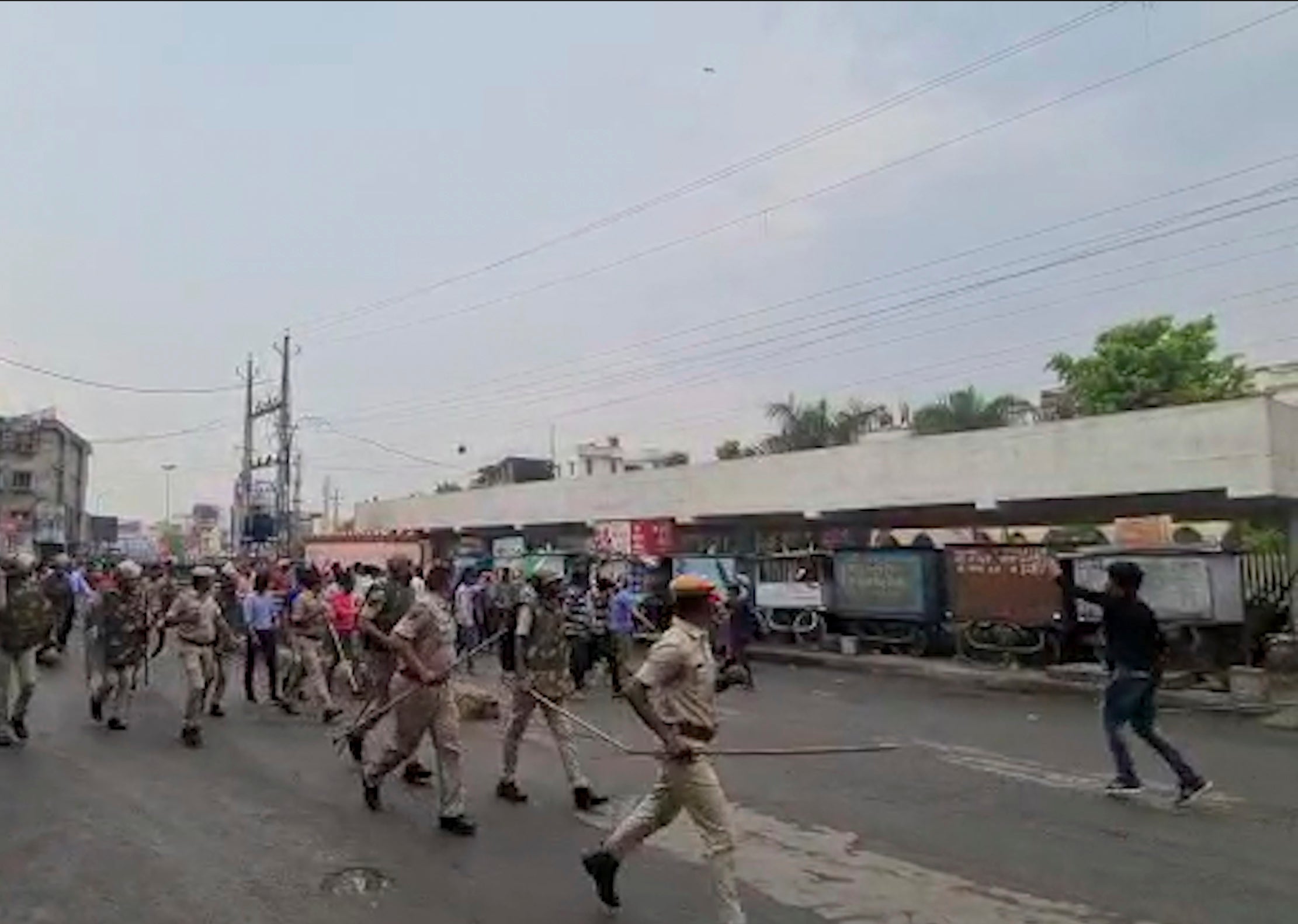 Police try to control a crowd shouting slogans during a protest soon after the beheading