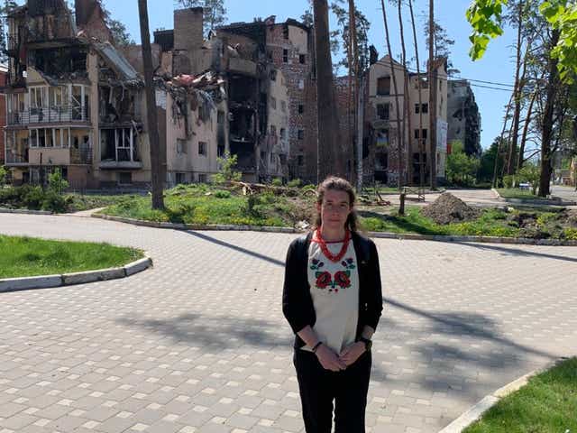 Welsh diplomat Kate Davenport, who is based in Ukraine, outside a bombed building in Irpin (Foreign, Commonwealth and Development Office/PA)