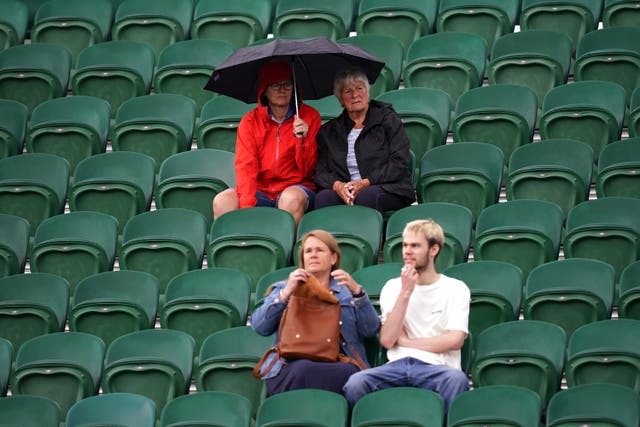 Spectators with umbrellas on day two of the 2022 Wimbledon Championships at the All England Lawn Tennis and Croquet Club, Wimbledon. Picture date: Tuesday June 28, 2022 (John Walton/PA)