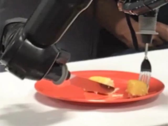 <p>Researchers at Johns Hopkins connected a robotic arm to a paralysed person’s brain, allowing the patient to feed themselves by thinking of commands</p>