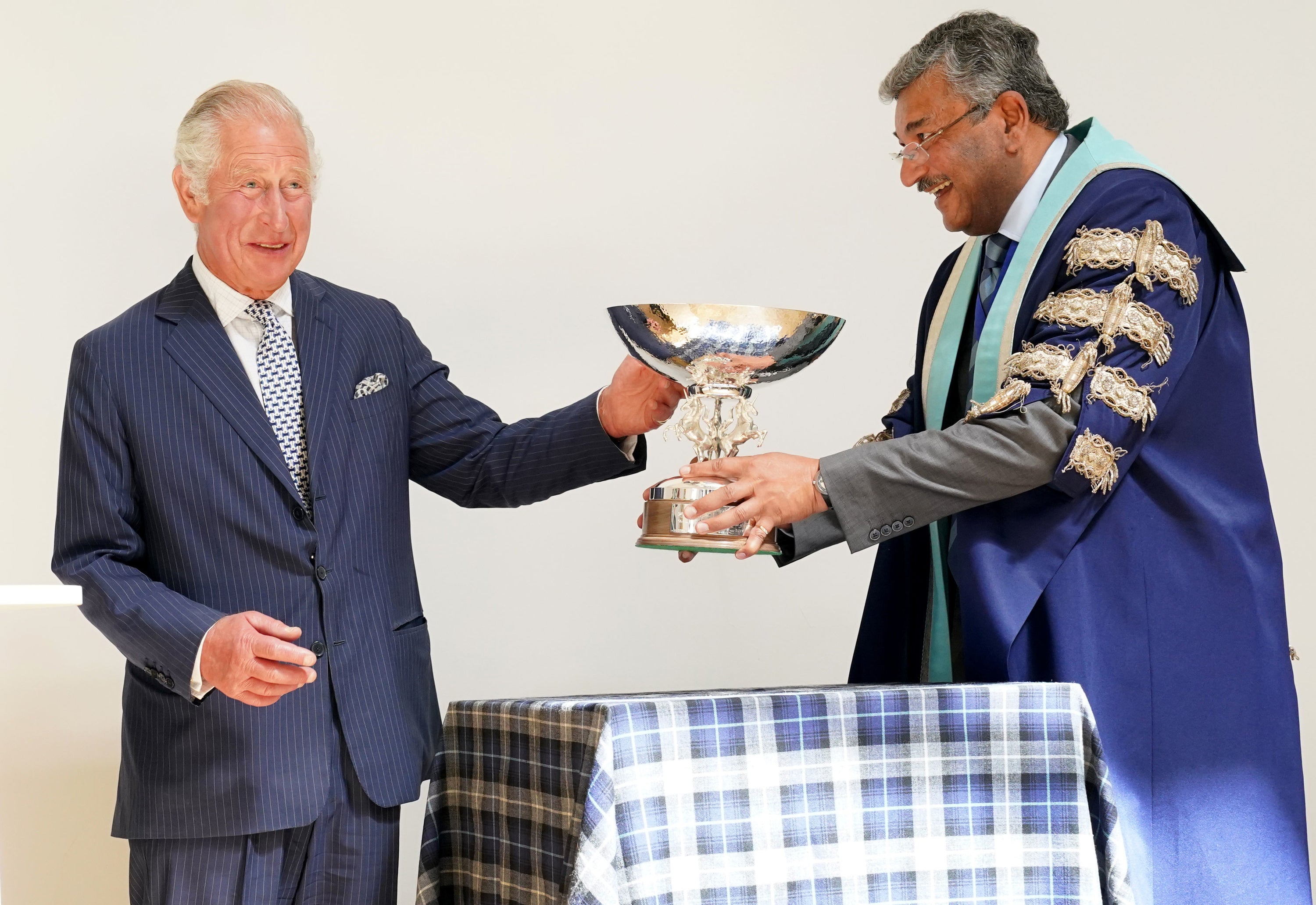 Charles is presented with a commemorative bowl during his visit (Jane Barlow/PA)