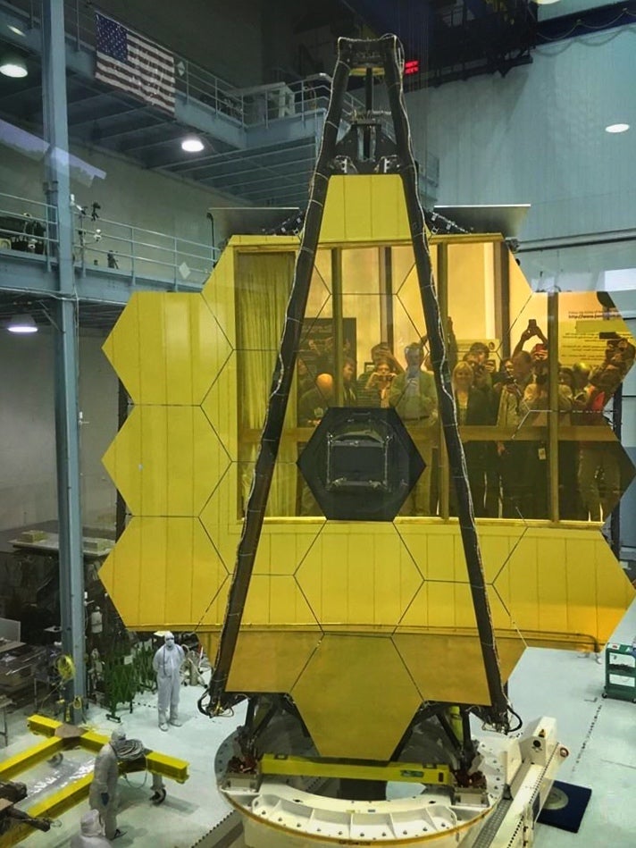 Visitors view the primary mirror of the James Webb Space Telescope in 2017 in the Nasa Goddard Space Flight Center clean room.