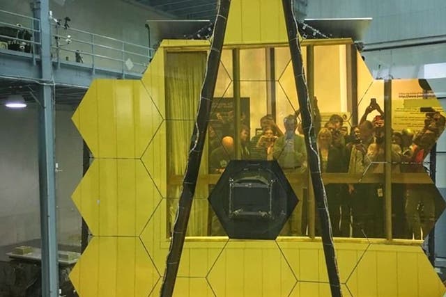<p>Visitors view the primary mirror of the James Webb Space Telescope in 2017 in the Nasa Goddard Space Flight Center clean room. </p>