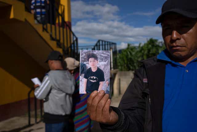 <p>A man shows a portrait of Wilmer Tulul, in Tzucubal, Guatemala, Wednesday, June 29, 2022 </p>