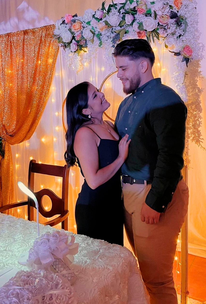 In this undated photo provided by Karen Caballero, her son Alejandro Miguel Andino Caballero and his girlfriend Margie Tamara Paz Grajera pose for a photo at an undisclosed location in Honduras.