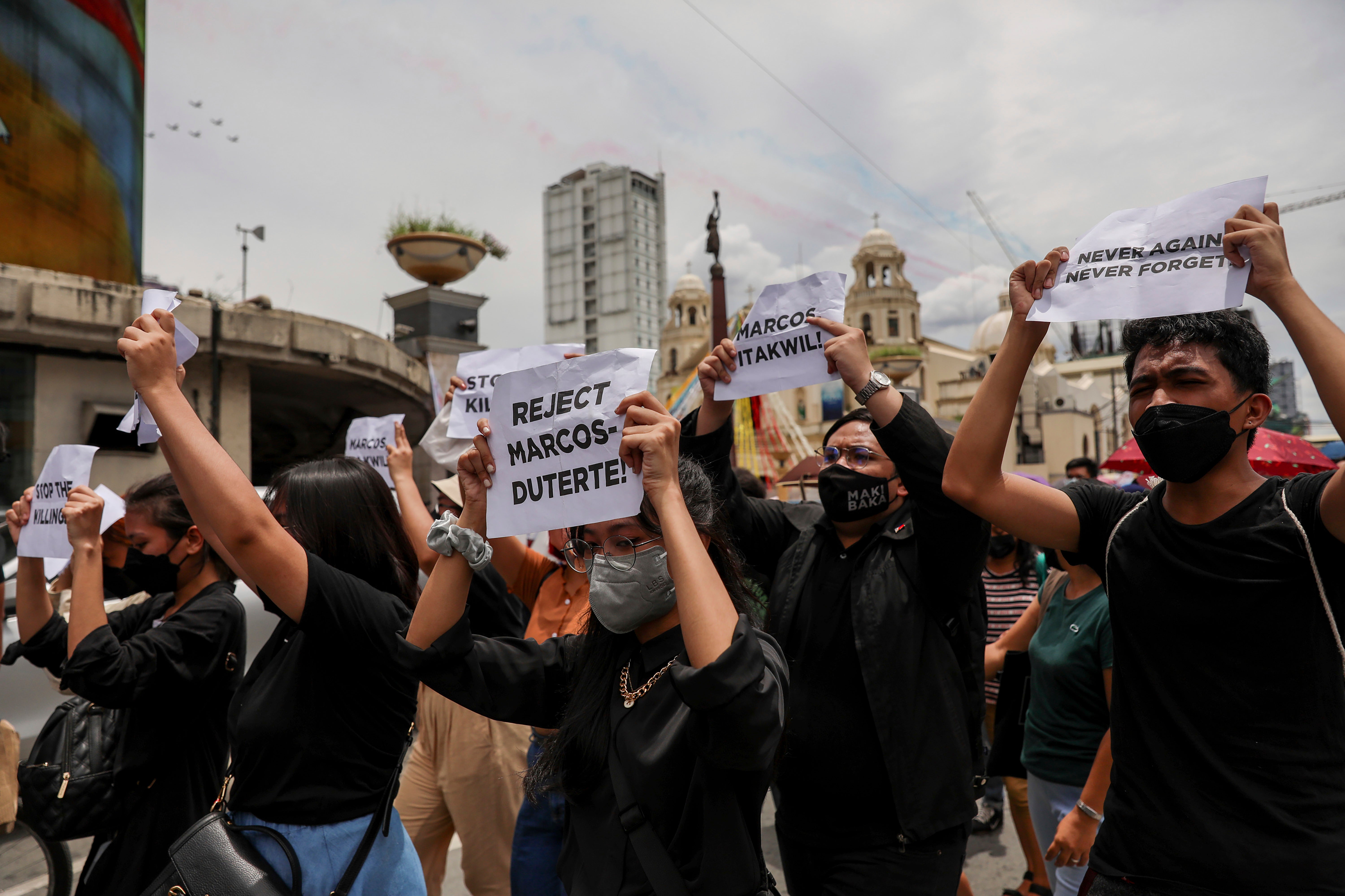 Activists hold signs against the inauguration ceremony of president-elect Ferdinand Marcos Jr