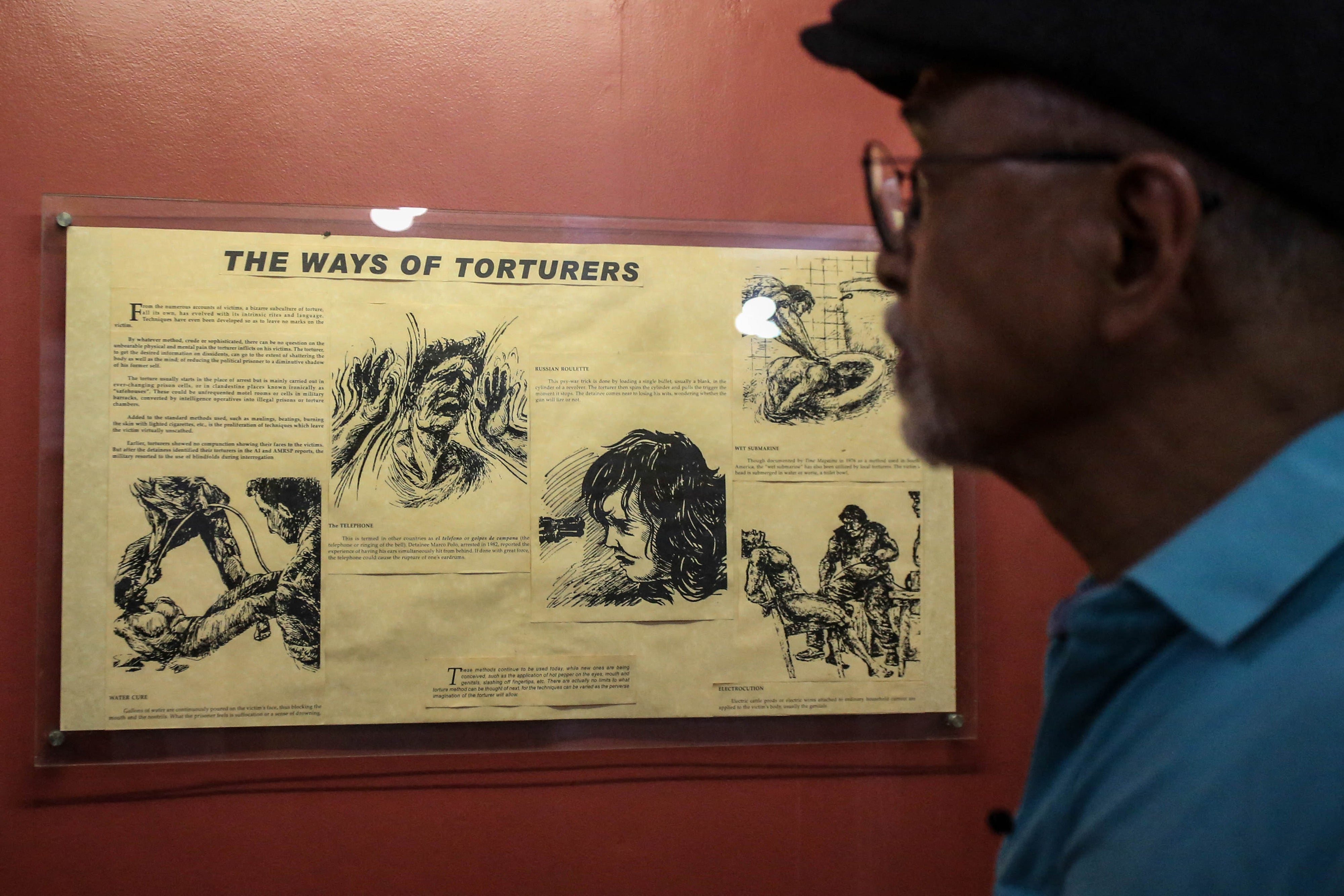 Former political prisoner Bonifacio Ilagan looking at a display about torture during the martial law era at a museum in Quezon City honouring people who took part in the struggle against former Philippine dictator Ferdinand Marcos in the 1970s