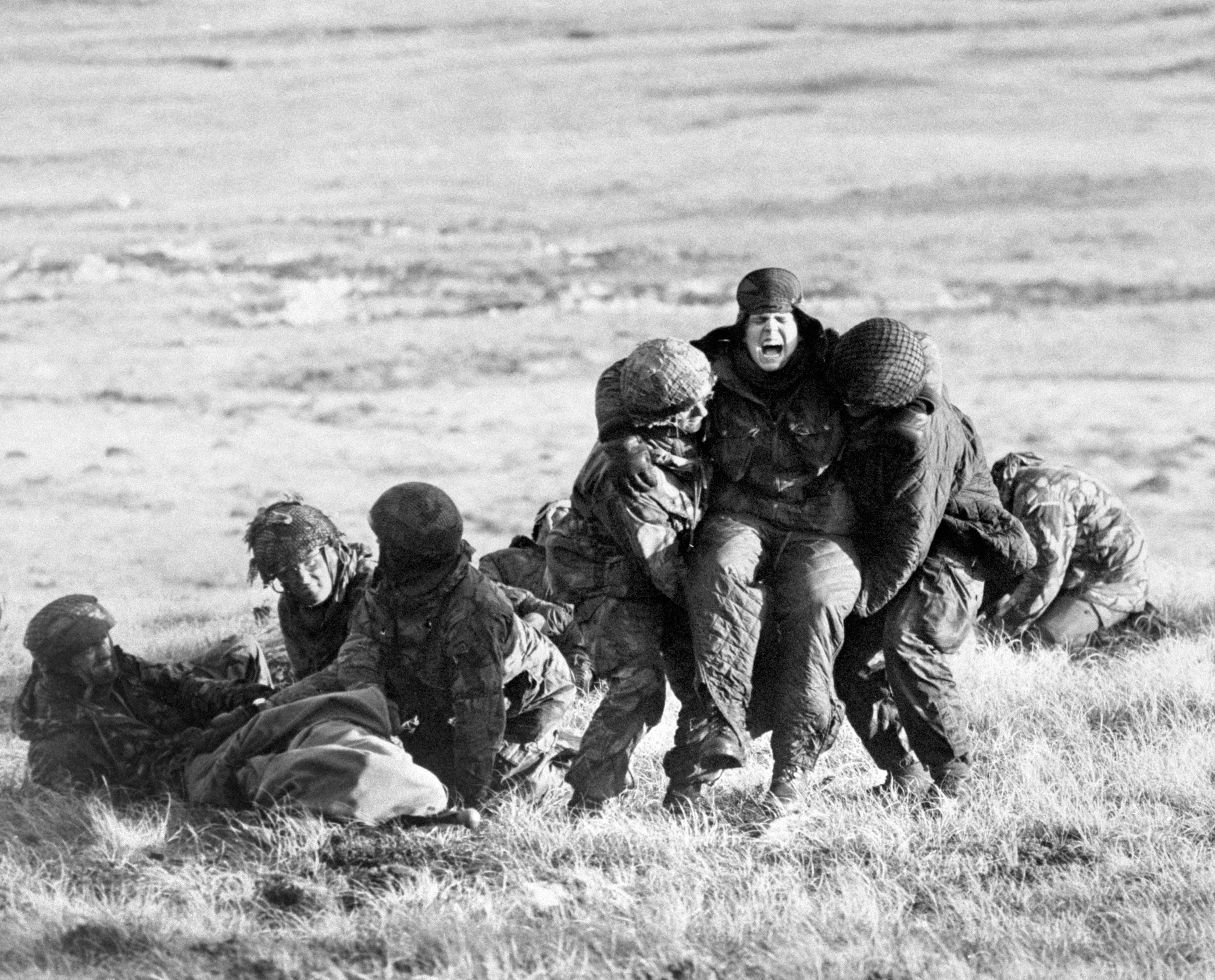 British paratroopers carrying out emergency medical treatment on wounded comrades whilst under fire on Mount Longdon during the Falklands campaign in 1982 PA Photo