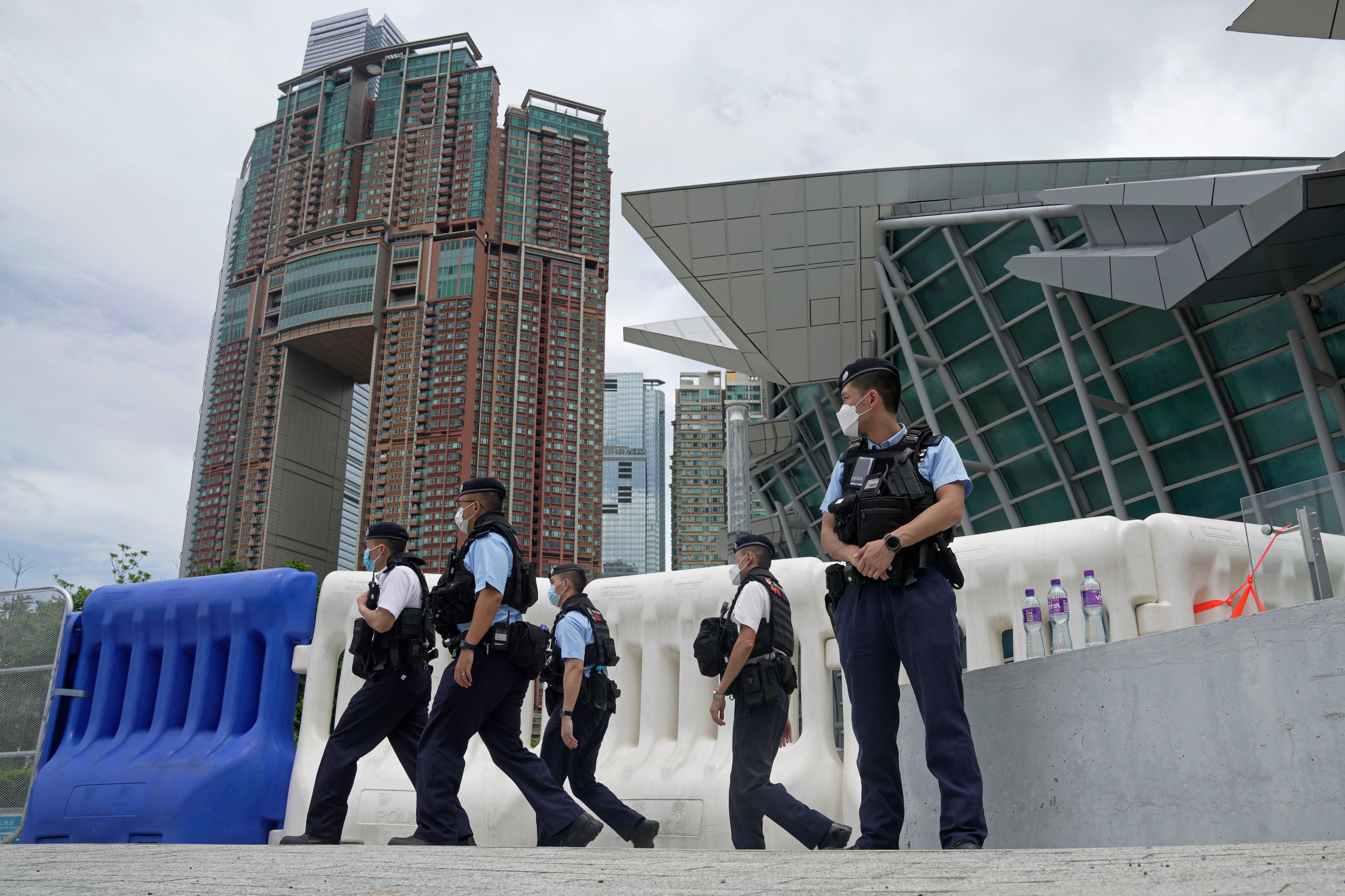 Police officers patrol outside the high speed train station for Chinese president Xi Jinping’s visit