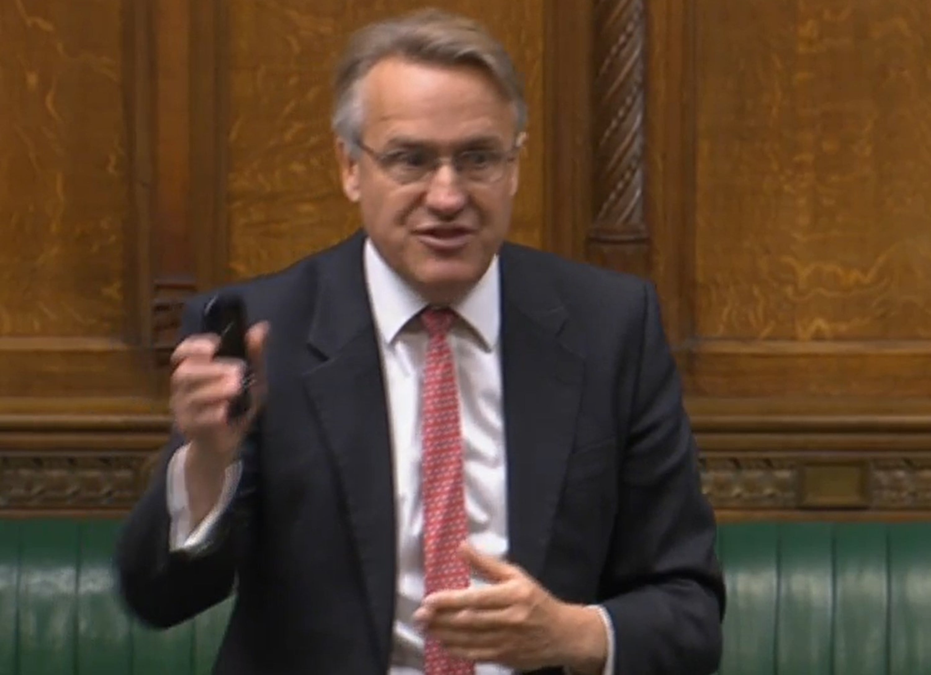 Sir Charles Walker waving his mobile device (House of Commons/PA)