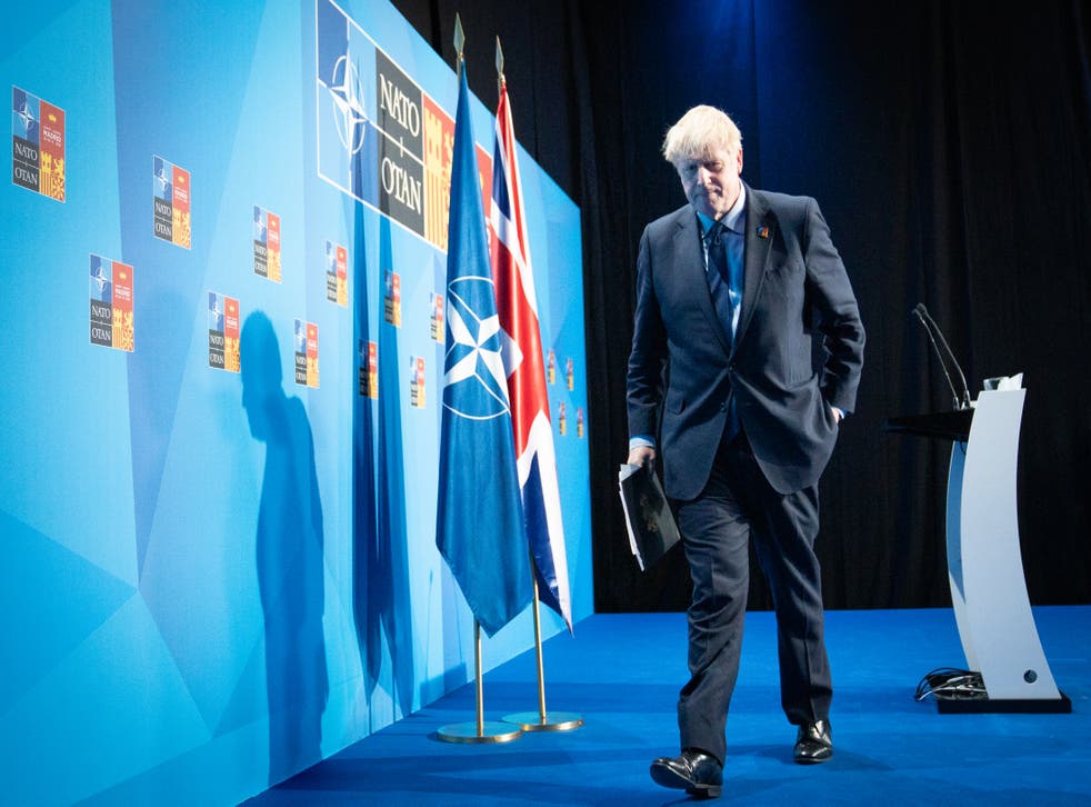 Boris Johnson leaves the stage after holding a news conference at the end of the Nato summit (Stefan Rousseau/PA)