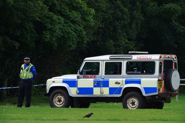 Police at the scene in the Sarn area of Bridgend, south Wales, near to where five-year-old Logan Mwangi was found dead in the Ogmore River on Saturday. Picture date: Tuesday August 3, 2021.