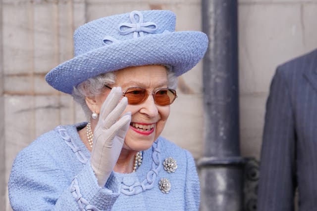 The Queen smiled and waved as she took in the ceremony at the Palace of Holyroodhouse (Jane Barlow/PA)