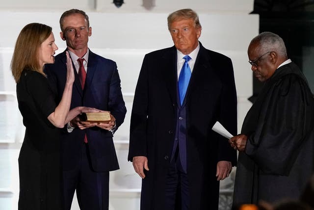 <p>President Donald Trump watches as Supreme Court Justice Clarence Thomas administers the Constitutional Oath to Amy Coney Barrett on the South Lawn of the White House White House in Washington, Oct. 26, 2020</p>