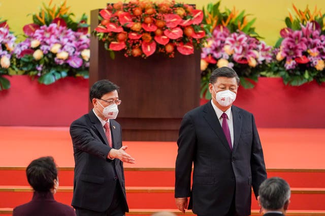 <p>Hong Kong’s new chief executive John Lee (left) gestures to Chinese president Xi Jinping on 1 July </p>