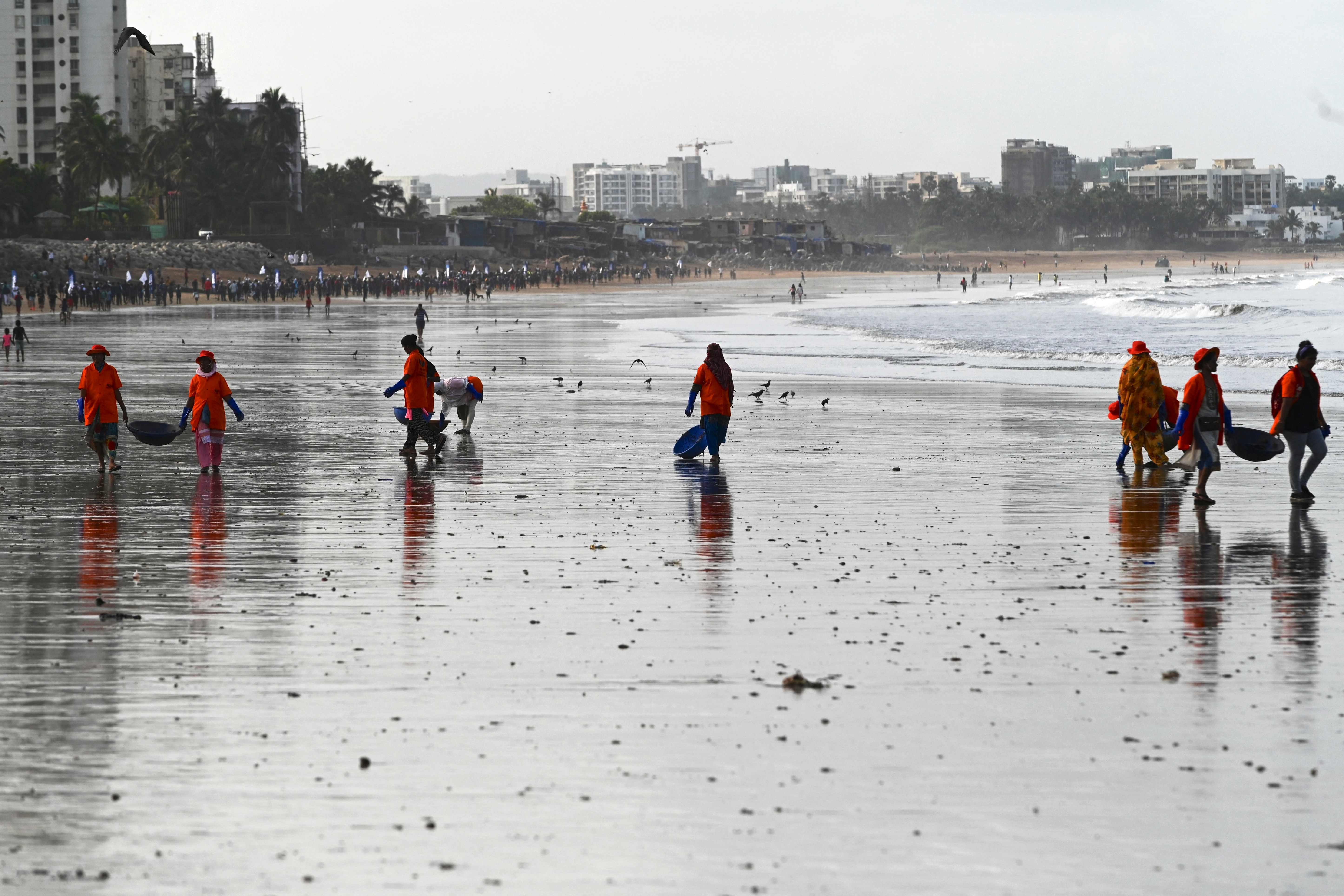 Civic staff and environmentalists clear rubbish from Versova Beach in Mumbai on World Environment Day