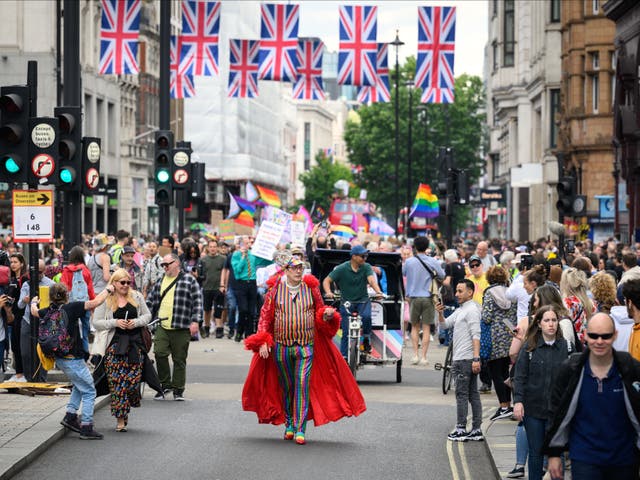 <p>Gay rights activists march along Oxford Street during an event to mark fifty years since the first UK Pride March at Trafalgar Square</p>