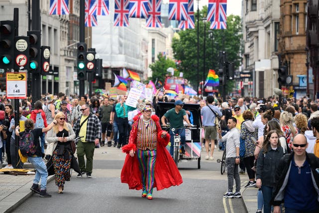 <p>Gay rights activists march along Oxford Street during an event to mark fifty years since the first UK Pride March at Trafalgar Square</p>