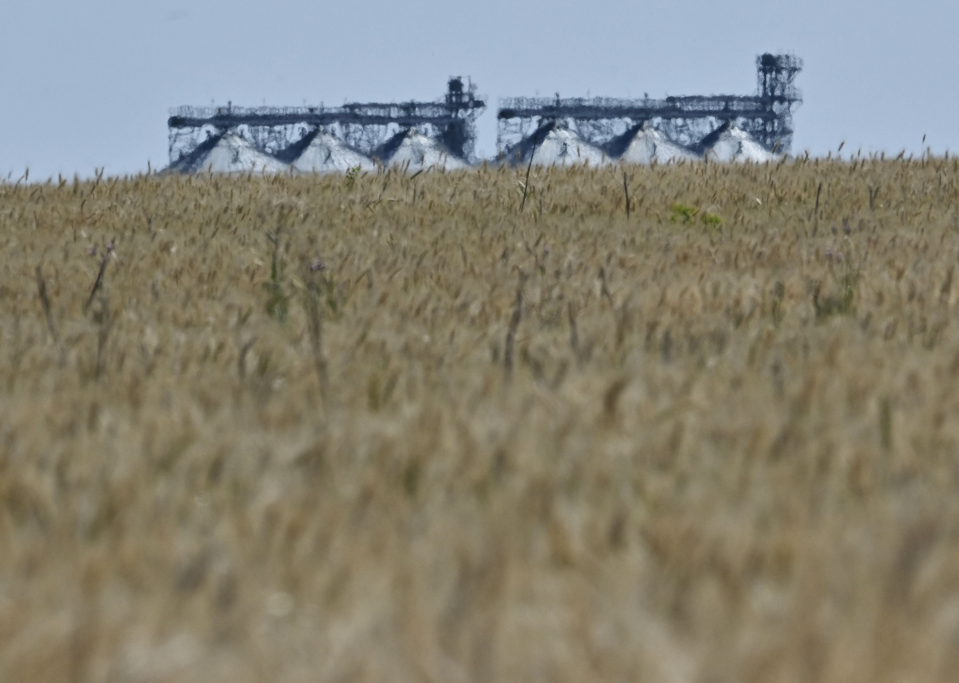A grain elevator behind a wheat field in Ukraine’s eastern region of Donbas, on 1 July 2022