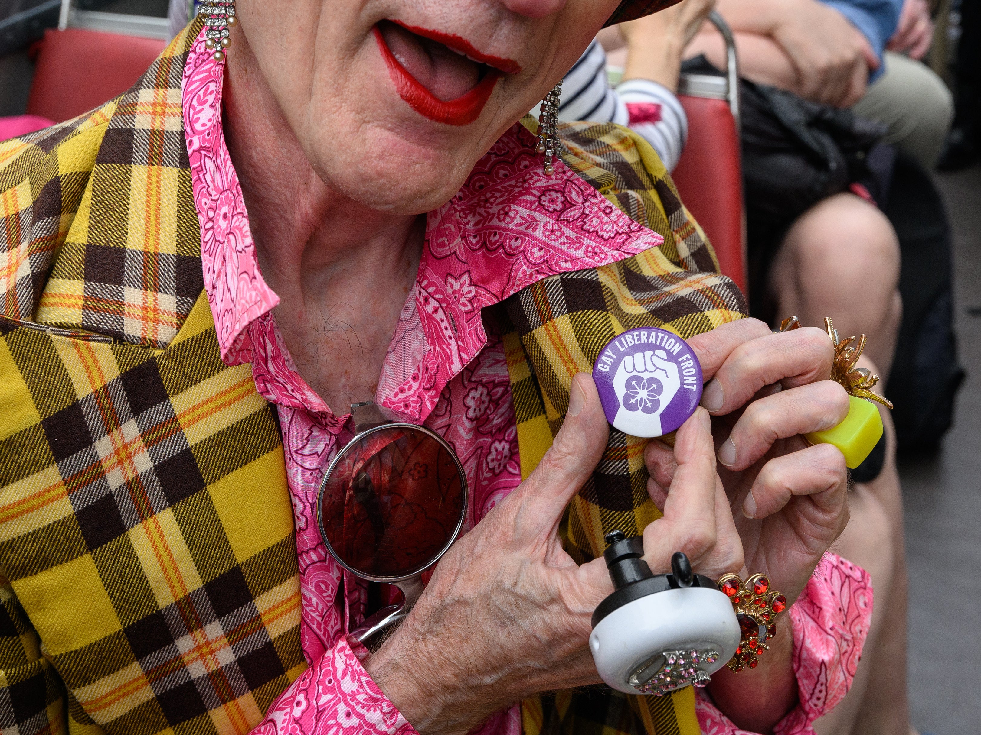 A gay rights activist attaches a new badge