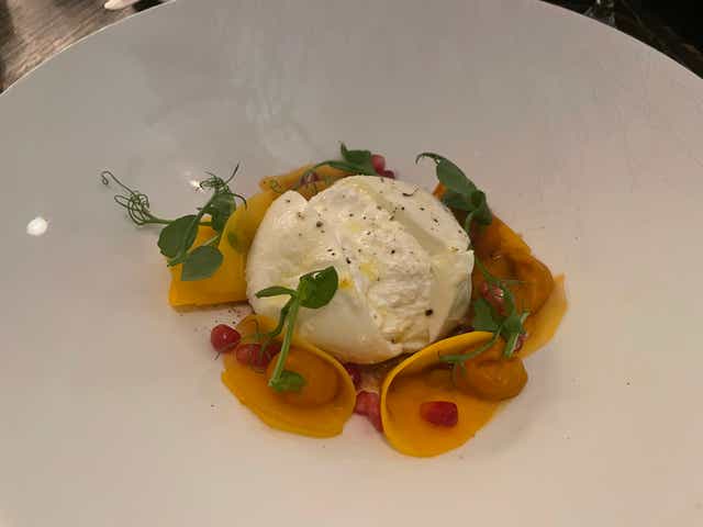 <p>A burrata and tomato salad catches our eye, a combination that can do no wrong, if you don’t think about the carbon footprint of burrata for too long</p>