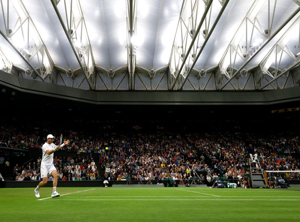 Great Britain’s Andy Murray in action against USA’s John Isner during the second round match on centre court with the roof closed during day three of the 2022 Wimbledon Championships at the All England Lawn Tennis and Croquet Club, Wimbledon. Picture date: Wednesday June 29, 2022. PA Photo. See PA story TENNIS Wimbledon. Photo credit should read: Steven Paston/PA Wire. Editorial use only. No commercial use without prior written consent of the AELTC. Still image use only – no moving images to emulate broadcast. No superimposing or removal of sponsor/ad logos.