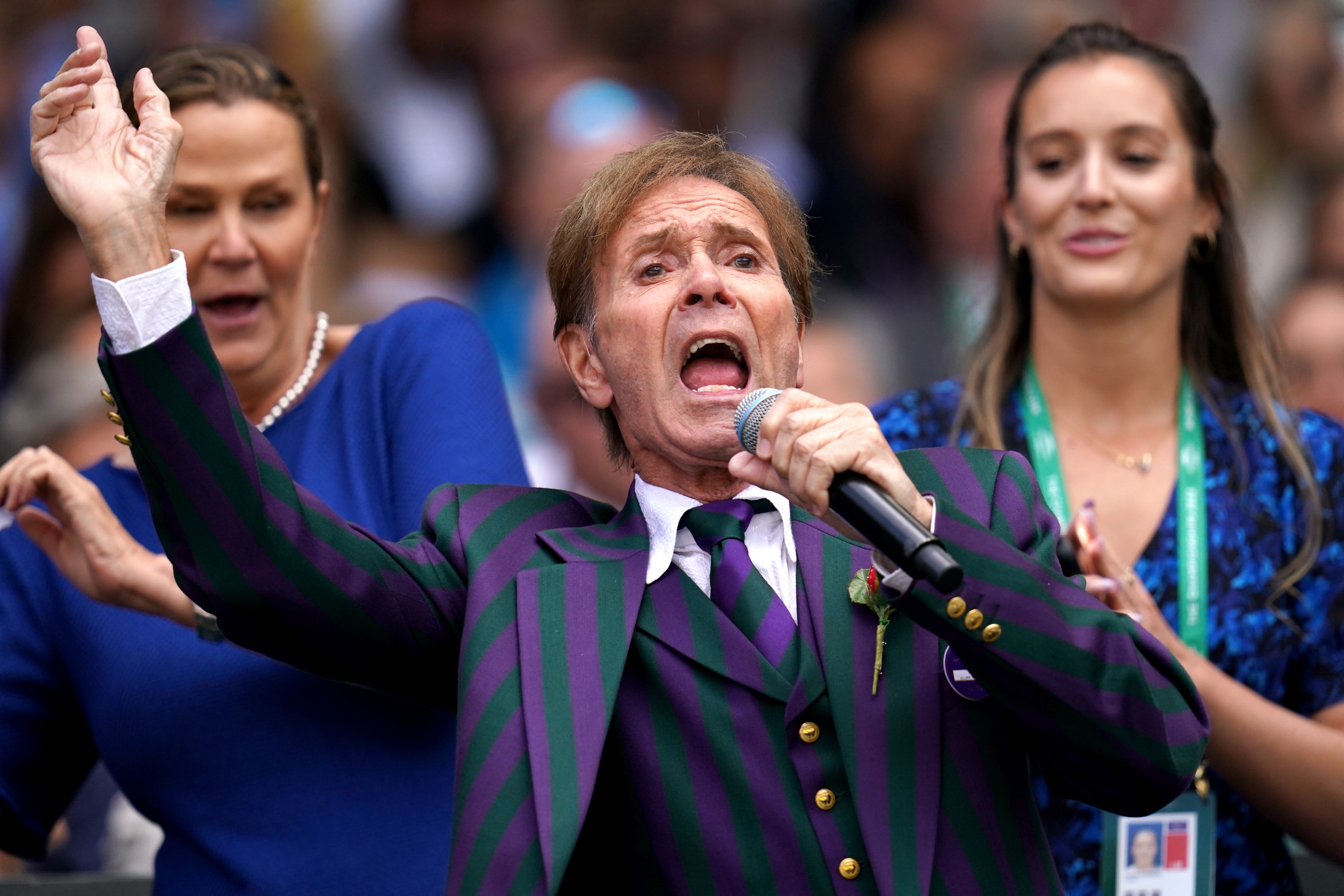 Sir Cliff Richard with backing singers Pam Shriver (left) and Laura Robson (John Walton/PA)