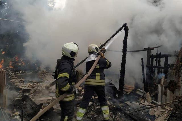 <p>Ukrainian firefighters work to extinguish a fire at damaged residential building in Lysychansk</p>