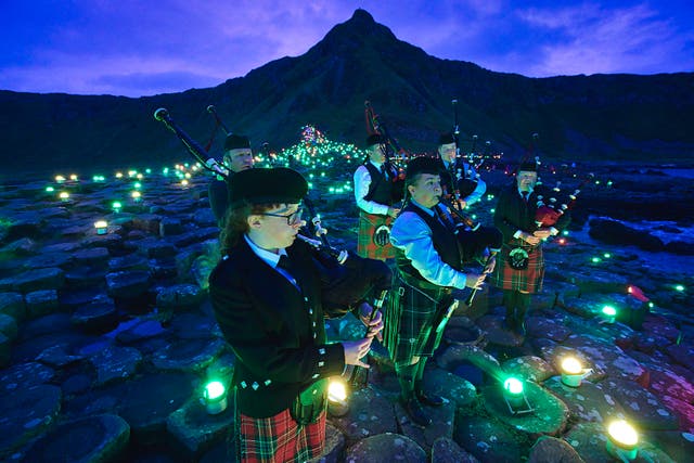 Lumenators create a large-scale art work at the Giant’s Causeway as part of Unboxed (Brian Morrison/PA)