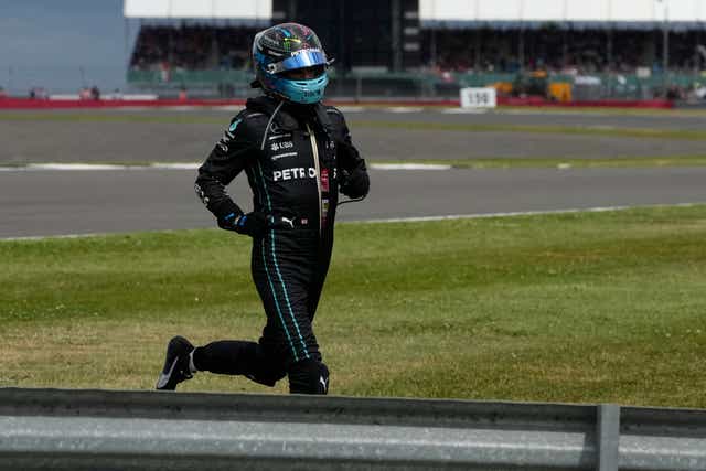 <p>Mercedes driver George Russell of Britain runs to his car during the British Formula One Grand Prix</p>