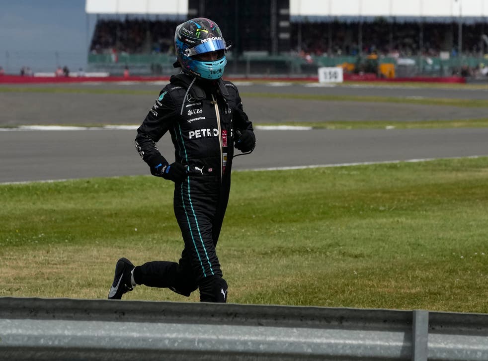 <p>Mercedes driver George Russell of Britain runs to his car during the British Formula One Grand Prix</p>