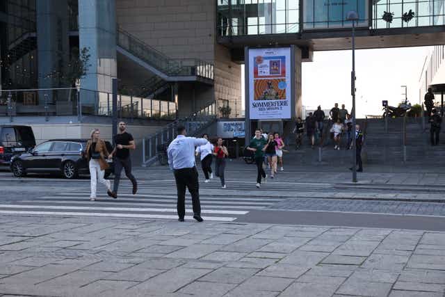 <p>People run in front of the Field's shopping center during an evacuation by armed police</p>