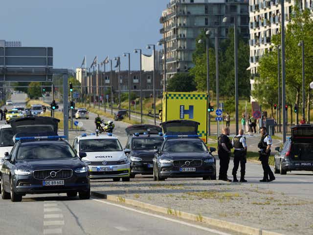 <p>Police officers gather outside Fields shopping centre after several people were shot dead</p>