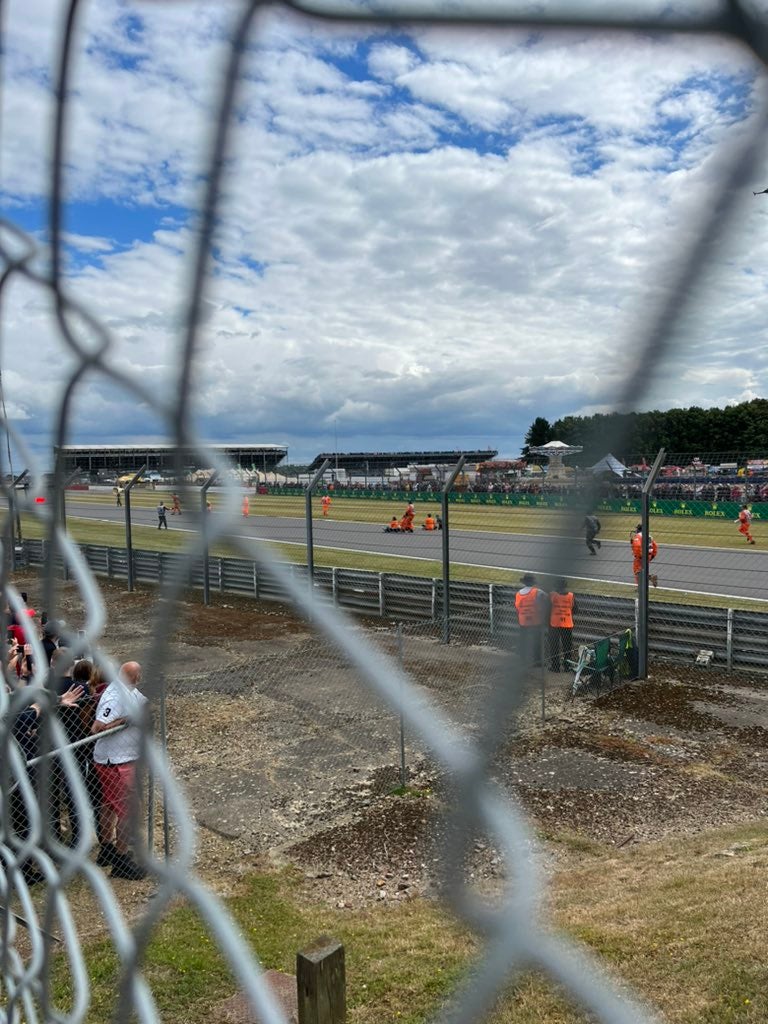 Protestors sit down on the Silverstone track