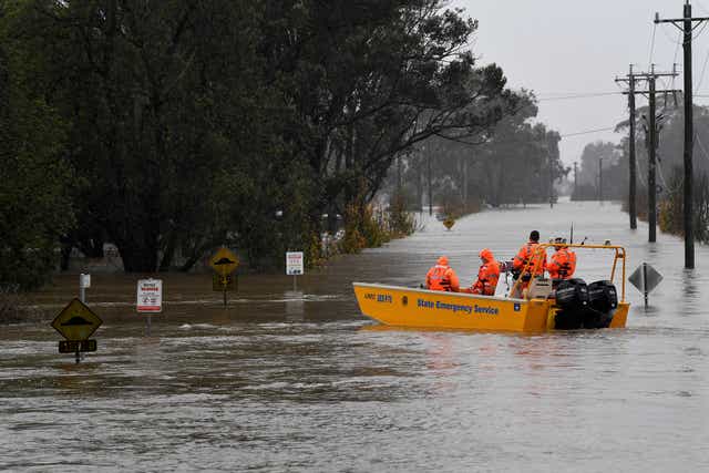 <p>A New South Wales State Emergency Service (SES) crew is seen in a rescue boat as roads are submerged under floodwater from the swollen Hawkesbury River </p>
