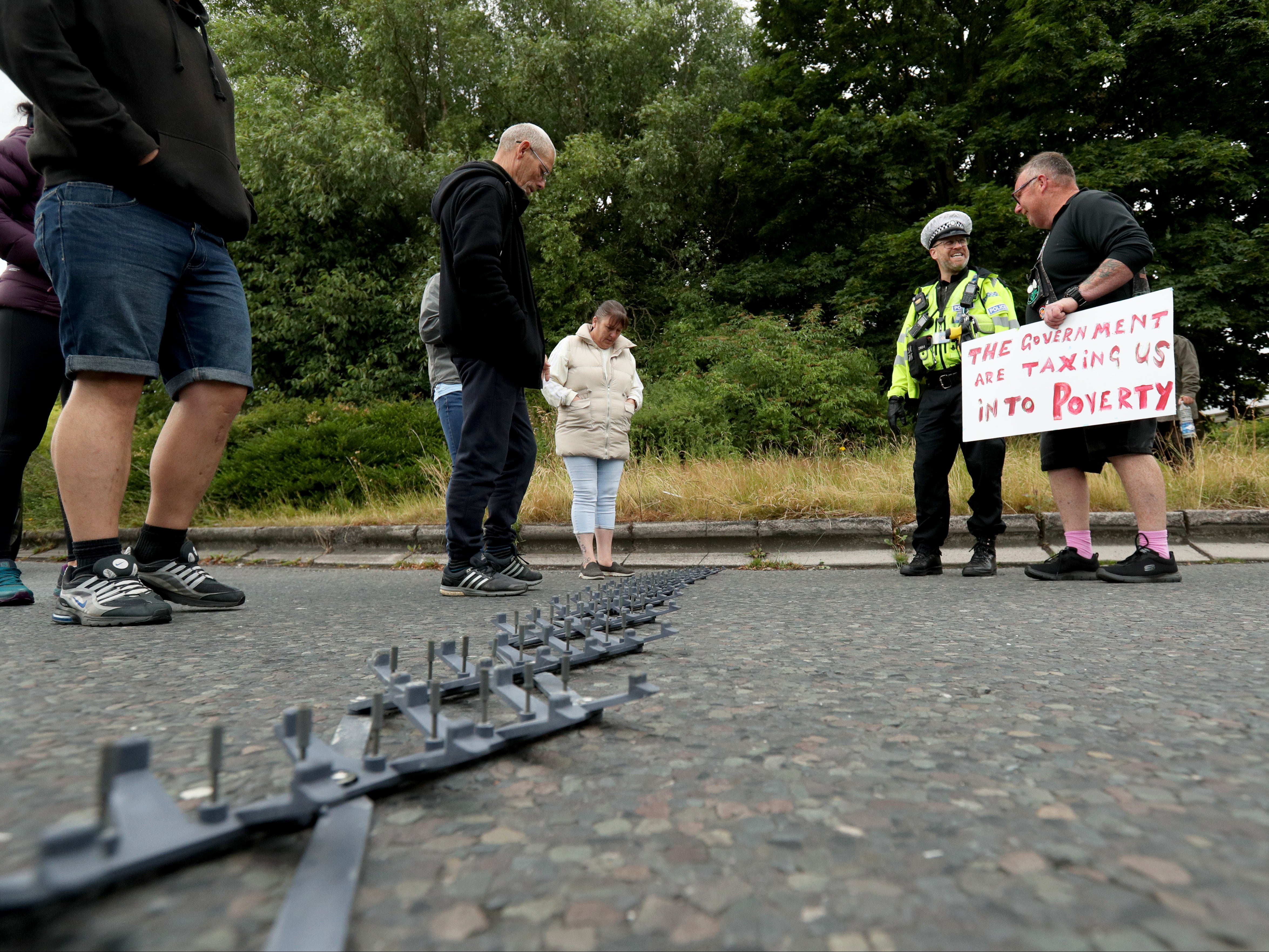 Protesters talk to the police after they deployed a stinger on the exit junction at Ferrybridge services in Leeds