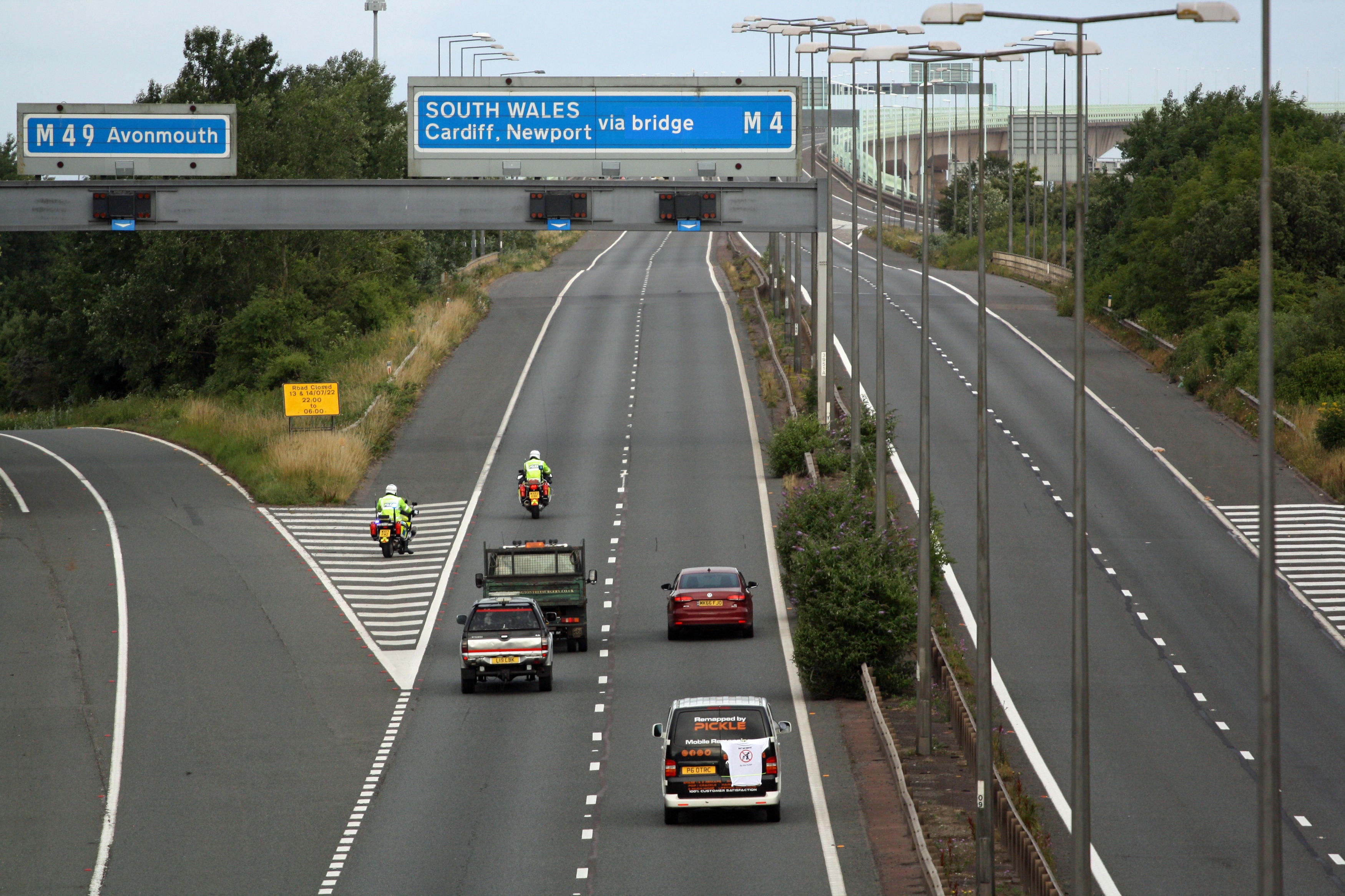 Police escort vehicles along the M4 motorway during the morning rush hour